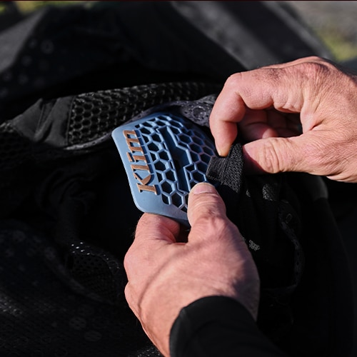 rouge armor being placed in jacket